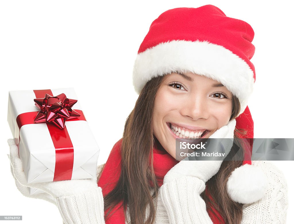 Mulher de Natal com presentes sorridente usando chapéu de Papai Noel - Foto de stock de 20 Anos royalty-free