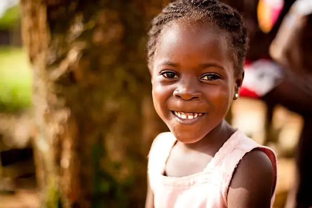 Photo of young african girl smiling happily