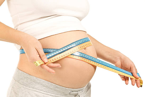 istock Measuring tape around protuberant abdomen 153763467