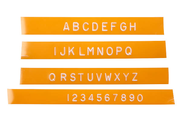 istock Punch letter alphabet on orange labeling tape 153763484