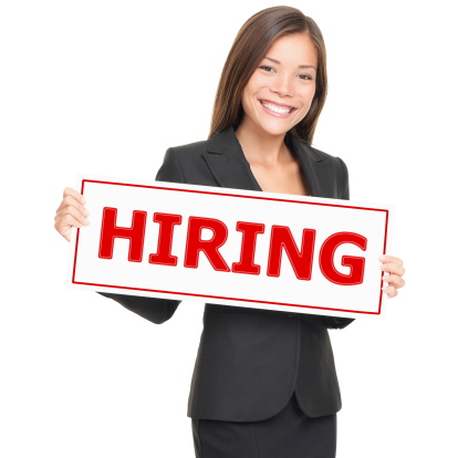 Job woman showing hiring sign. Young smiling Caucasian / Asian businesswoman isolated on white background.