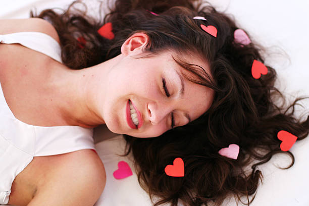 istock Beautiful young woman smiles while sleeping 153766036