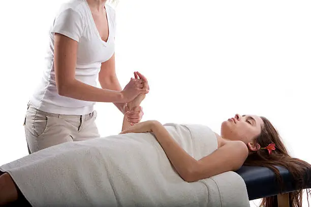 Massage therapist massaging woman's hand