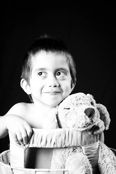 istock Little boy in wicker basket with his puppet dog 153766734