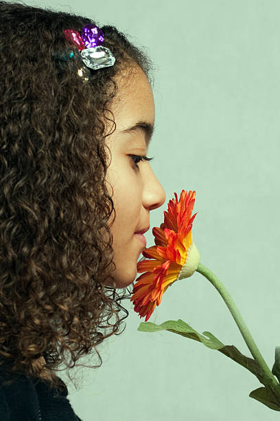 istock Young girl smelling orange flower 153767140