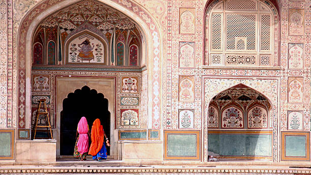 Woman in Amber fort Two women walking in the Amber Fort, Jaipur mahal stock pictures, royalty-free photos & images