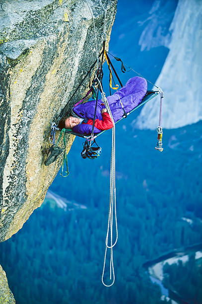 Rock climber in his shelter. stock photo