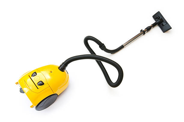 compact, modern vacuum cleaner placed neatly on the floor in a modern apartment.