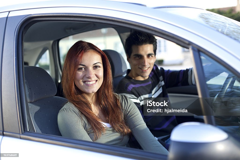 Young couple inside the car Young and happy couple inside a land vehicle for the begining of a long travel (selective focus with shallow DOF) 20-29 Years Stock Photo