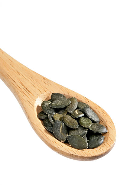 istock isolated pumkin seeds on a spoon 153768741