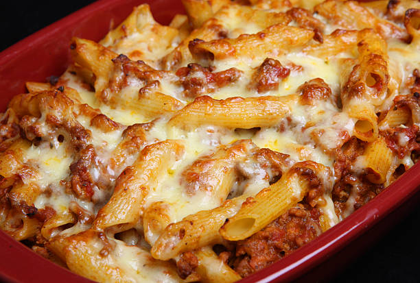 Rigatoni Pasta Gratin Bake Baked rigatoni pasta with bolognese sauce and cheese rigatoni stock pictures, royalty-free photos & images