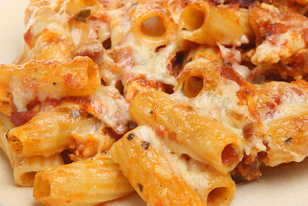 Pasta Bake at Gratin Rigatoni pasta tubes baked with tomato sauce and cheese. pasta casserole stock pictures, royalty-free photos & images