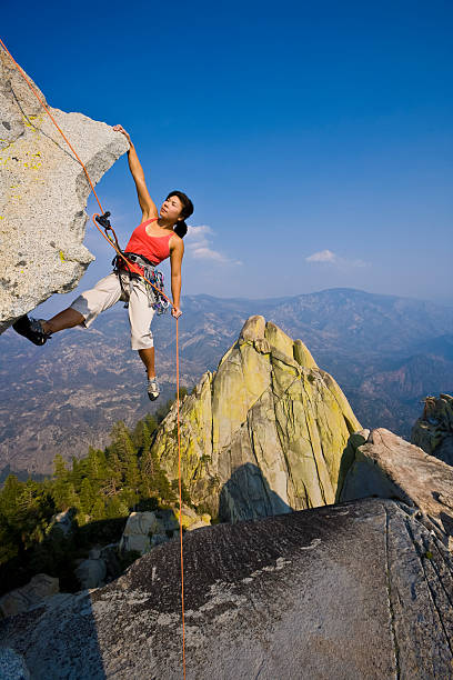 istock Female rock climber rappelling. 153770051
