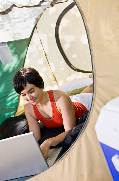 istock Woman using laptop in tent 153770233
