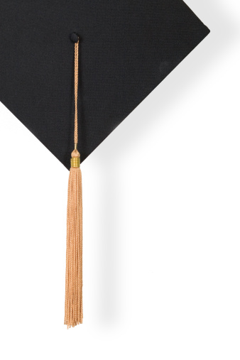 Graduation Cap with gold tassel on the white isolated