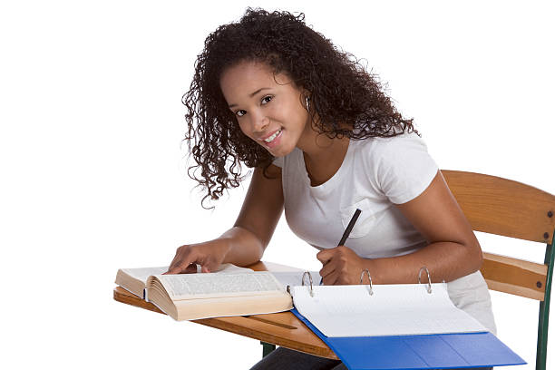 High school schoolgirl student with by desk studying stock photo