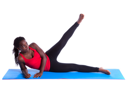 young african woman exercising with perfect body balance (isolated on white)
