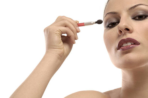 istock woman making herself up 153771543