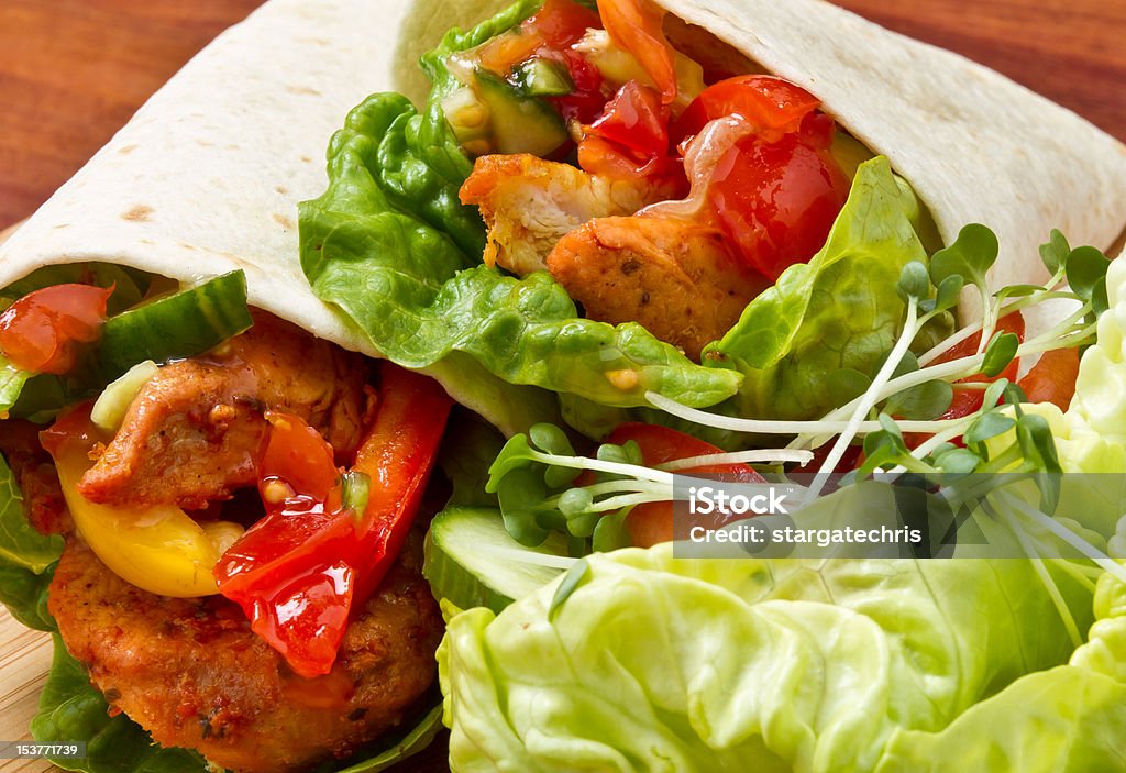 Spicy Chicken Wrap Spicy chicken with salad and salsa wrapped in a soft flour tortilla. Backgrounds Stock Photo