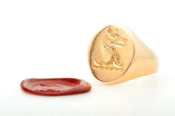 Gold signet ring and red wax seal.