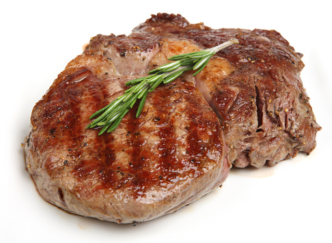 Juicy rib-eye beef steak with rosemary.