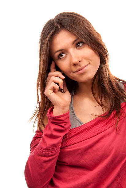 Pretty young woman talking on new cell phone mobile isolated on a white background