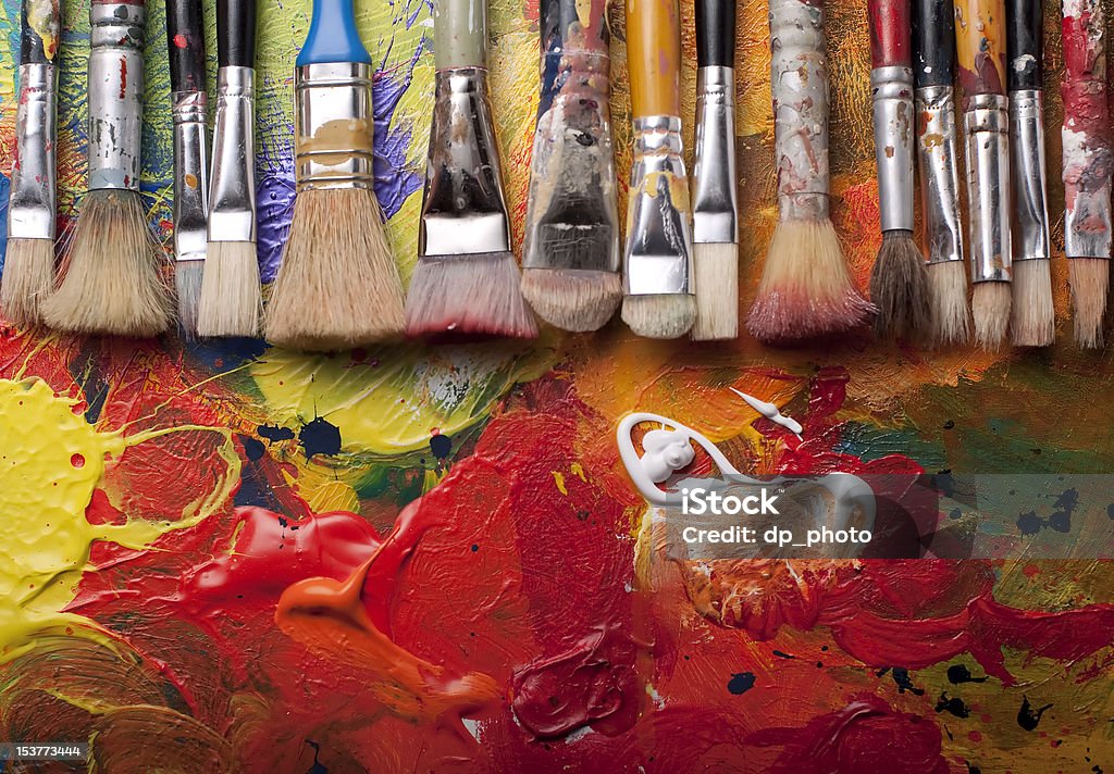 Paint brushes in a row Paint brushes in a row,pallete at background,studio shoot Art Studio Stock Photo