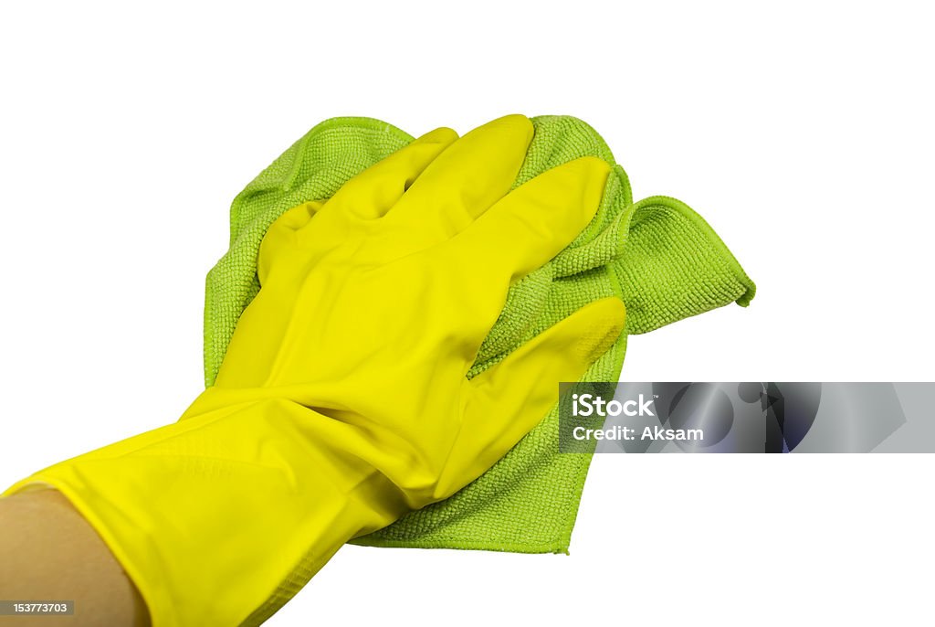 Hand in a glove with rag Hand in a yellow rubber glove and a green rag. On a white background Cleaning Stock Photo