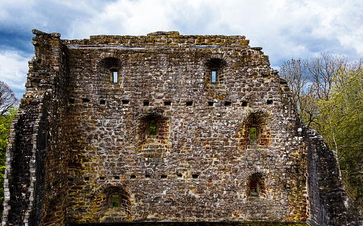 Panorama of an old wall with a walled-up archway