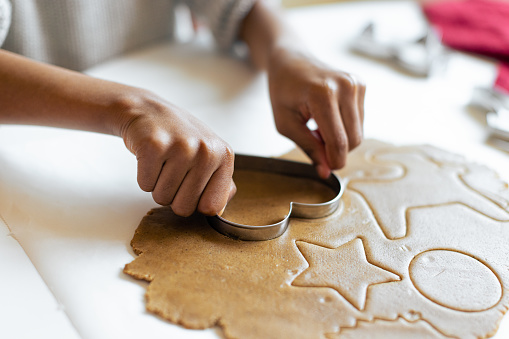 Christmas time. Close - up hands making gingerbread cookies