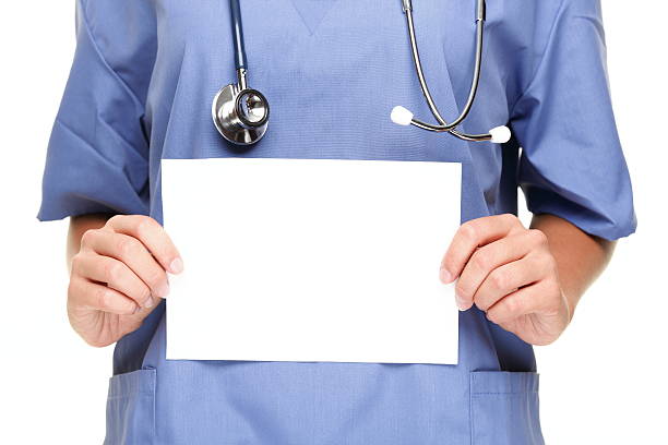Doctor showing blank sign stock photo