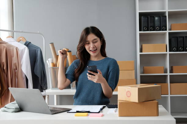 istock Startup girl Small SME business owners work with laptop computers at work. with parcel paper boxes for delivery to customers online selling. 1537776875