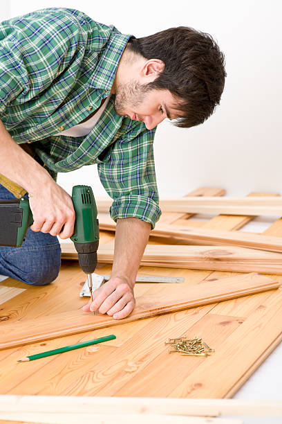 istock Home improvement - handyman installing wooden floor 153777987