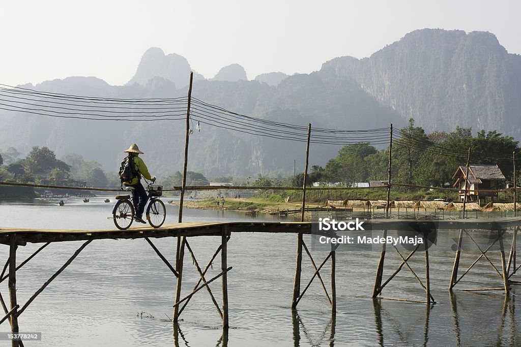 Cykling in Laos Bridge over lake in laos Bicycle Stock Photo