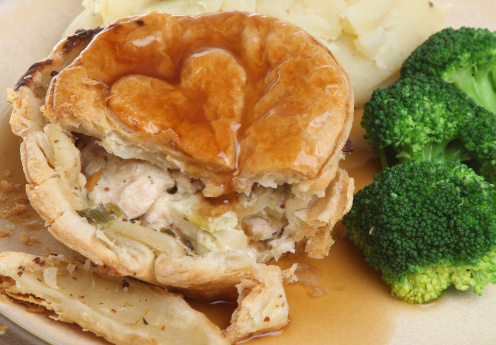 Chicken pie with mashed potato and broccoli.