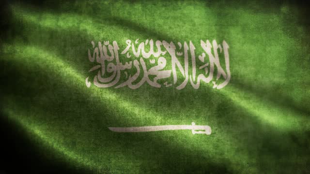 Closeup of grunge Saudi Arabia waving flag loopable stock video