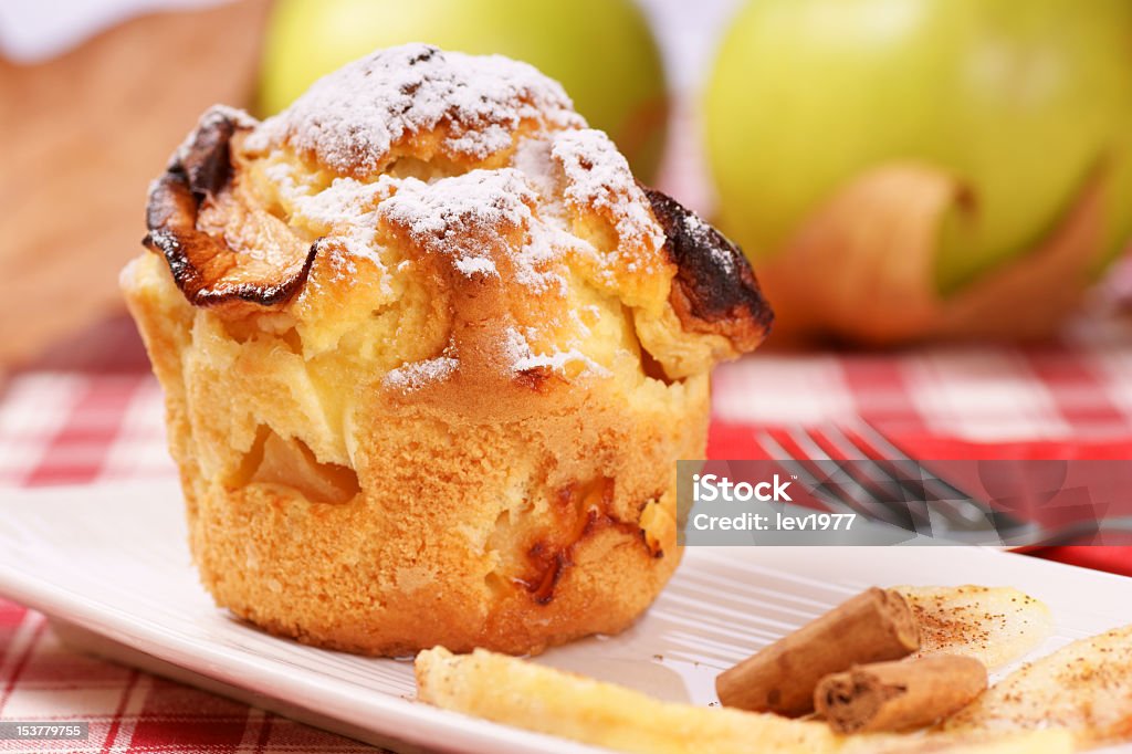 Apple muffin served on white plate  Apple muffin on a white plate with apples and leaves in the background. Apple - Fruit Stock Photo