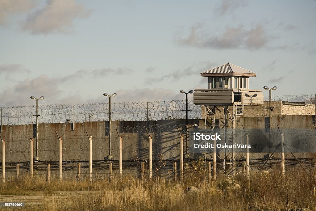 Prison Prison wall and guard tower. Prison Stock Photo