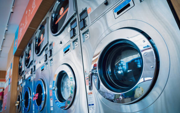 istock Rows of industrial laundry machines in the large laundromat. 1537806183