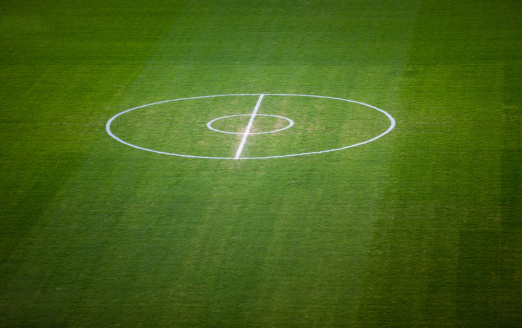 Australian Football field center bounce area. White circle lines on green grass. Shot with Canon 5DmkII, XXL.