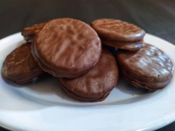 istock Sandwich Biscuits covered with Chocolate and Vanilla cream inside on a black background 1537810800
