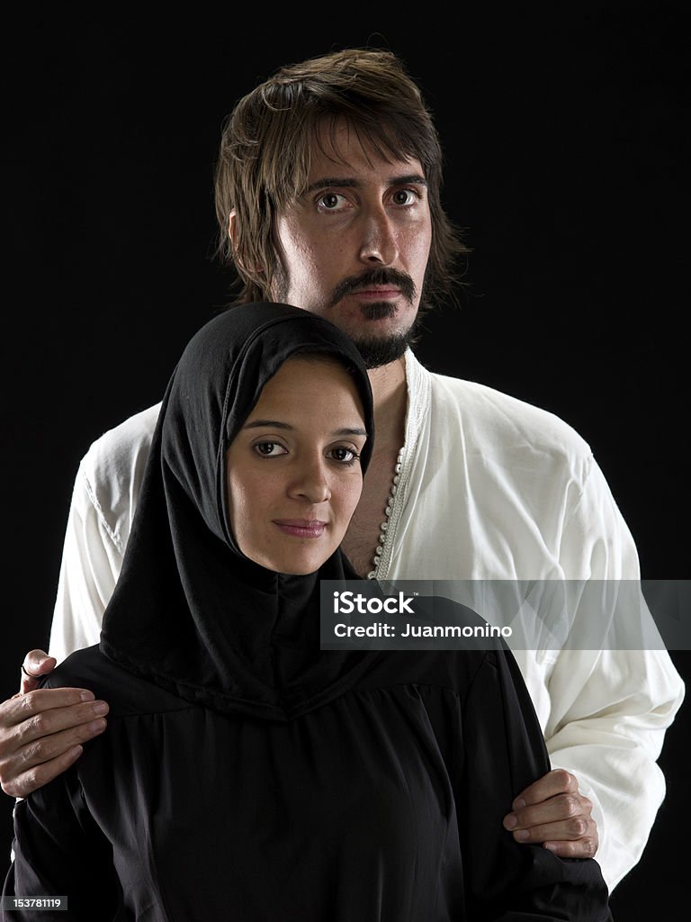 Smiling muslim couple Smiling middle eastern muslim couple on black background (this picture have been shot with a Hasselblad HD3 II 31 megapixels) 20-29 Years Stock Photo
