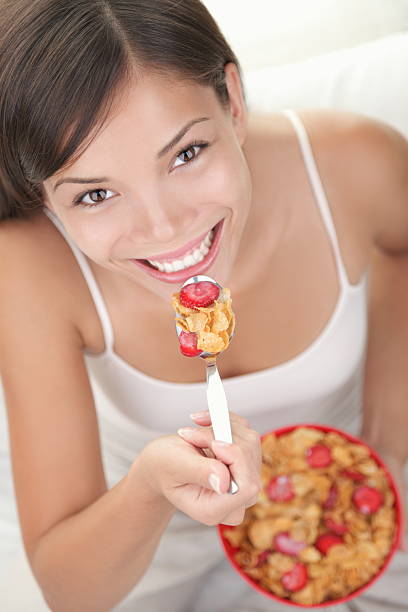 朝食のシリアルに食べる女性 - eating cereal student human mouth ストックフォトと画像
