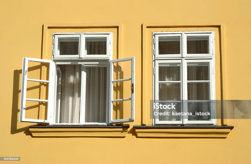 Two windows on yellow wall Antique Stock Photo