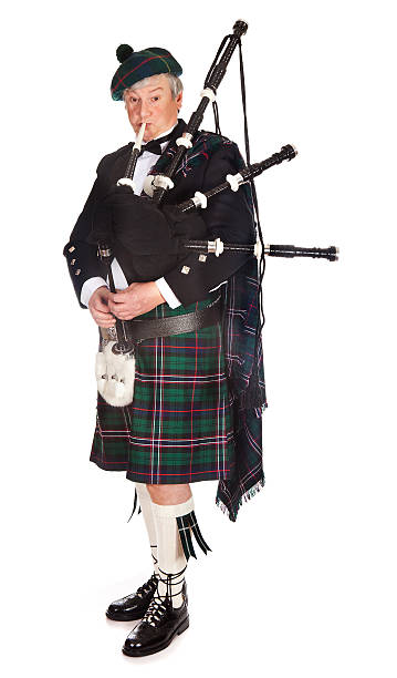Scottish bagpipes Scottish highlander wearing kilt and playing bagpipes kilt stock pictures, royalty-free photos & images