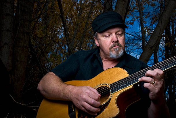 istock Guitar Man plays in the forest 153783463
