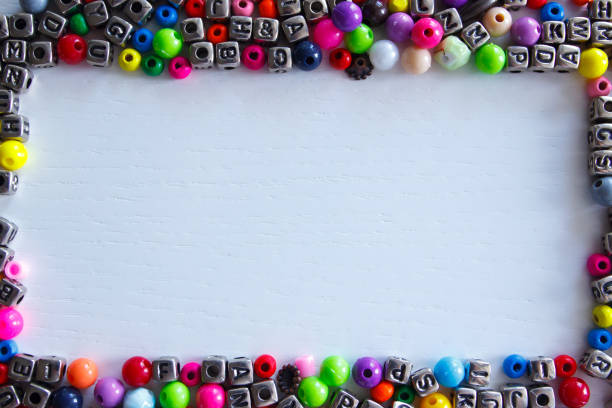 Background from different colored beads with numbers and symbols, top view