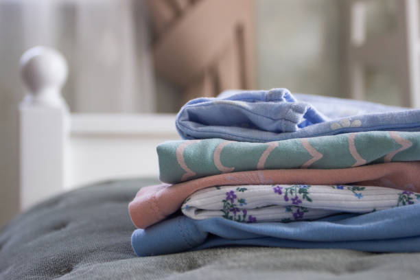 istock Clean colored clothes on the bed in a bedroom 1537837561