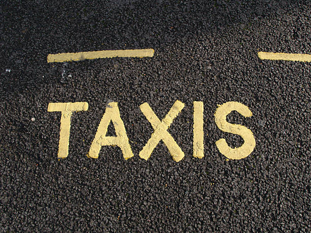 TAXIS - word written on the traffic lane stock photo