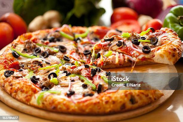 Supreme Pizza Slice Lift Stock Photo - Download Image Now - Pizza, Slice of Food, Gourmet